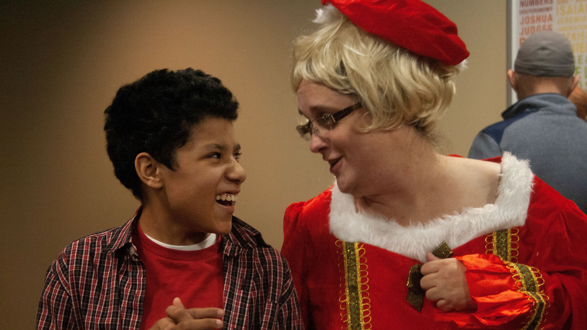 A volunteer dressed up at a Special Friends event at Brookwood Church interacts with a smiling Special Friend.